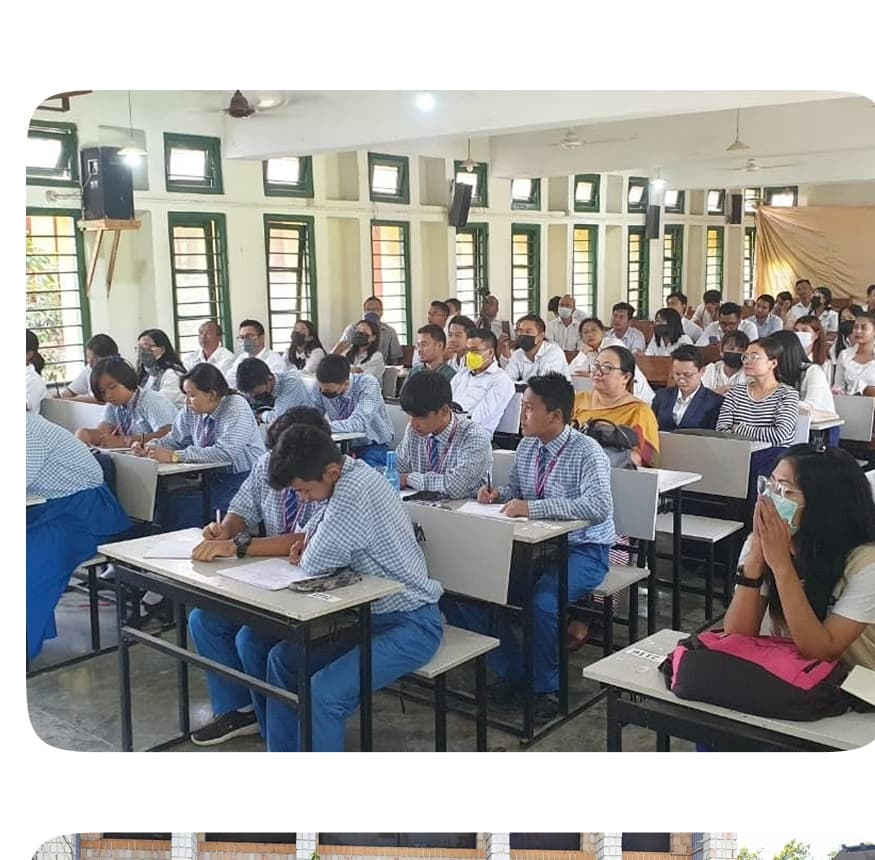Students sitting attentively during examination in the school hall