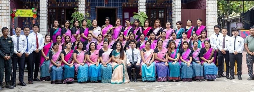 Kids' Foundation faculty members and students gathered in front of school building