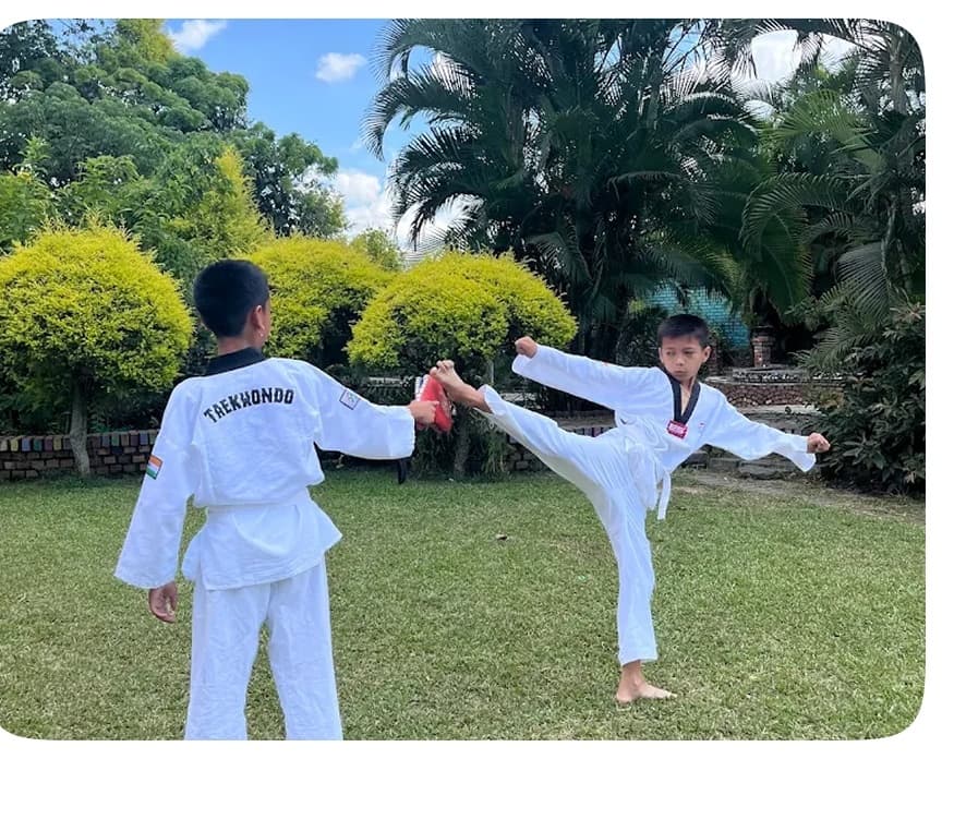 Students practicing taekwondo martial arts in the green school campus