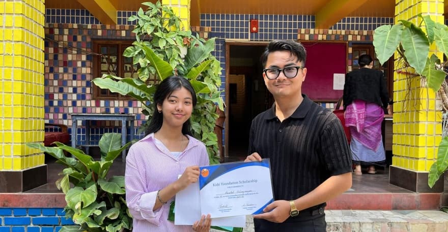 Scholarship awardee student receiving certificate at Kids' Foundation